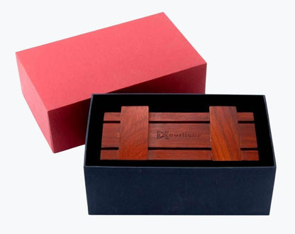 Rosewood wooden storage shaped as a chest for eyeglasses by NURILENS in a navy box.