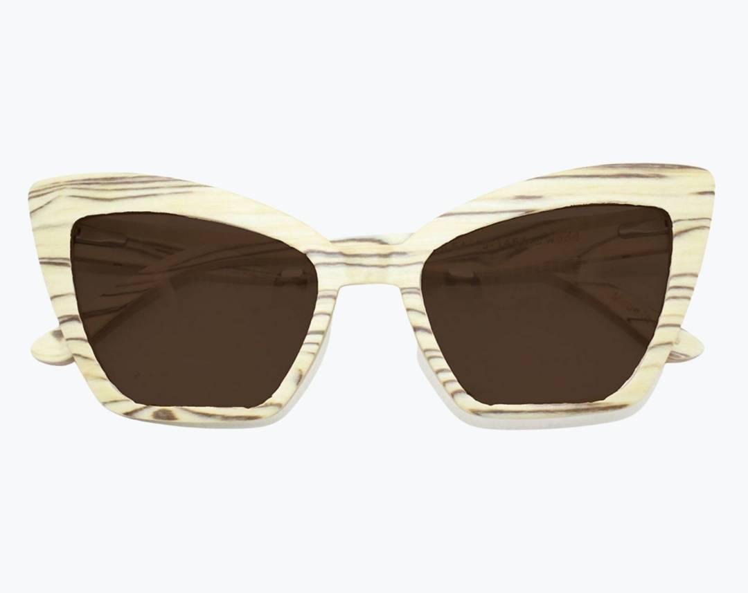 Folded beige cat eye wooden sunglasses made of ice wood with black striped wood grain accents with brown lenses by NURILENS.