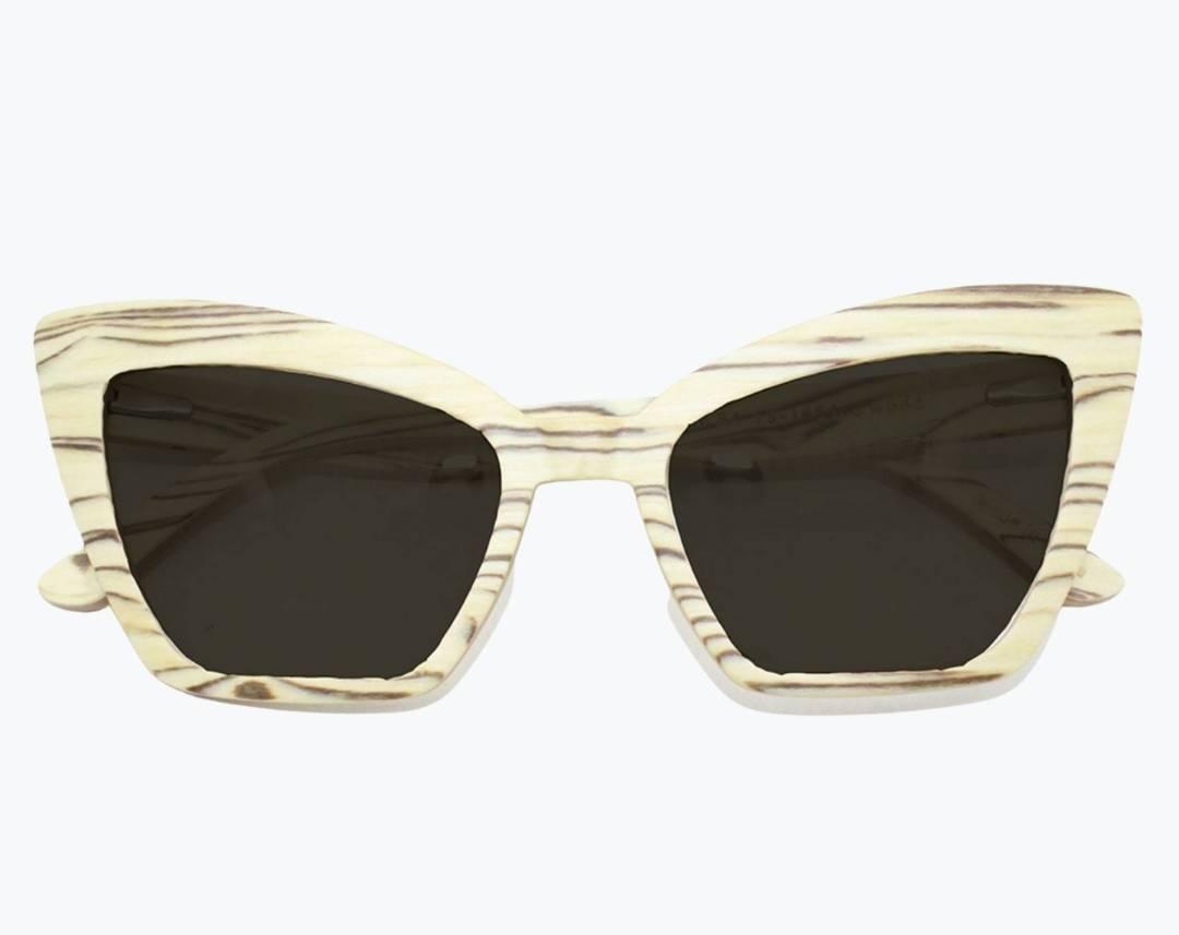 Folded beige cat eye wooden sunglasses made of ice wood with black striped wood grain accents with dark gray lenses by NURILENS.