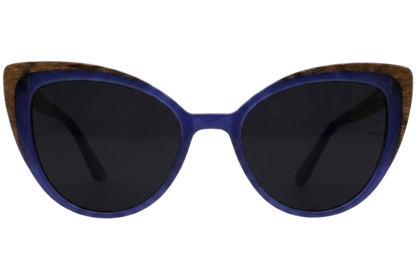 Cats-eye sunglasses with a vibrant blue acetate frame, dark lenses, and a natural wood inlay along the top edge, shown against a plain white background.