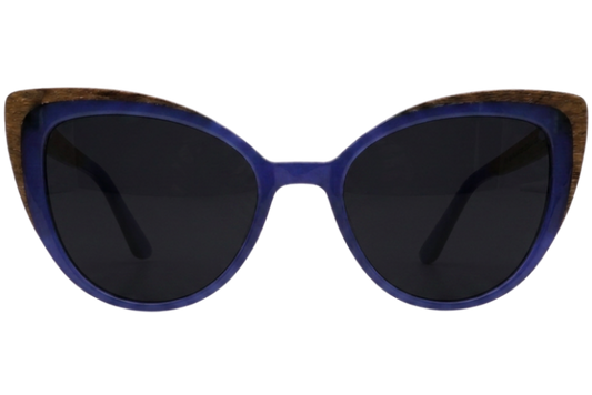 Cats-eye sunglasses with a vibrant blue acetate frame, dark lenses, and a natural wood inlay along the top edge, shown against a plain white background.
