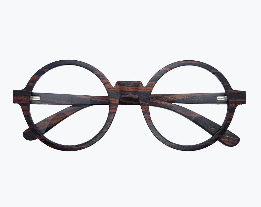 Folded pair of round wooden glasses made of ebony with subtle black wood grain by NURILENS.