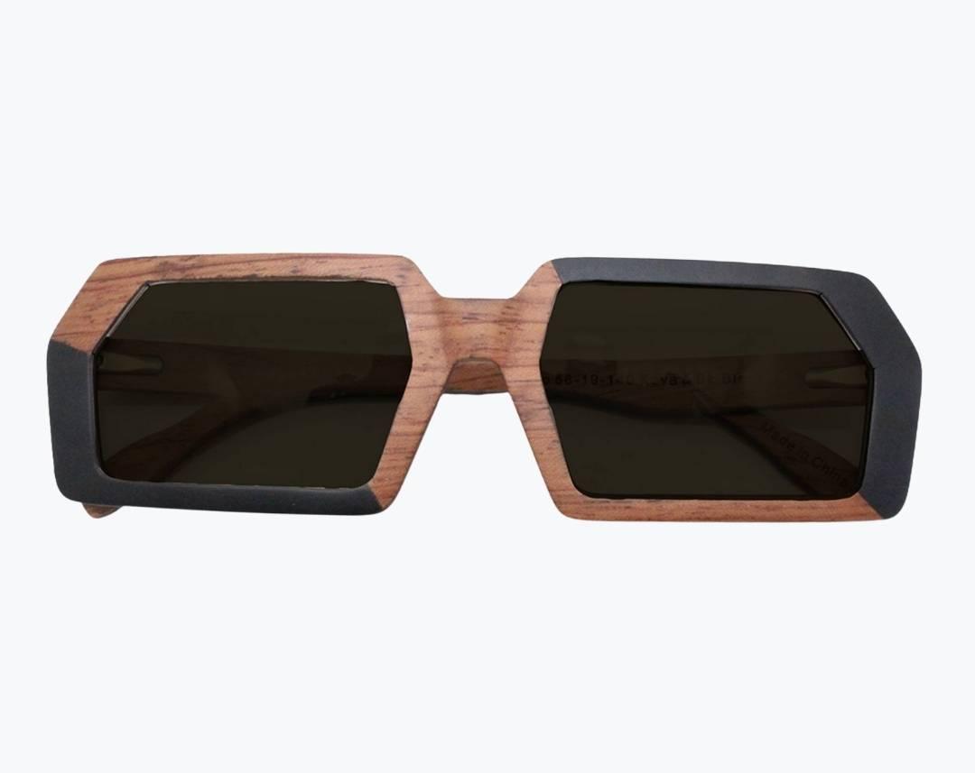 Folded brown and black rectangular wooden sunglasses with gray lenses made of black birch and brown kevazingo wood by NURILENS.