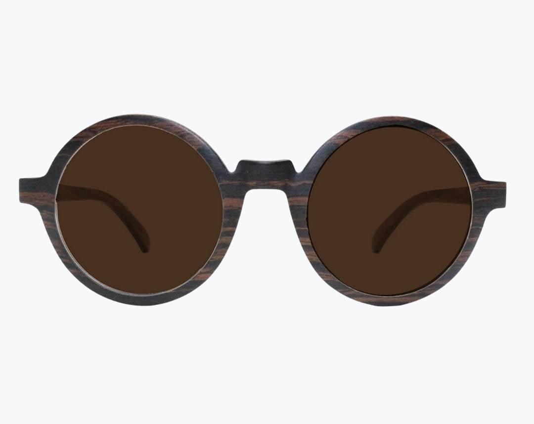 Round brown wooden sunglasses made of ebony with subtle black wood grain with brown lenses by NURILENS.