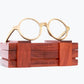 Round wooden glasses made of light brown Zebrawood with subtle black stripes sitting on rosewood wooden case by NURILENS.